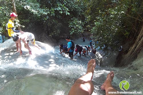 Trekking against the waterfall current at Aguinid