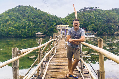 Striking a pose at the makeshift bamboo bridge in Tinagong Dagat