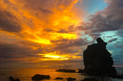 Vivid colors burst as the sun sets in Apo Island
