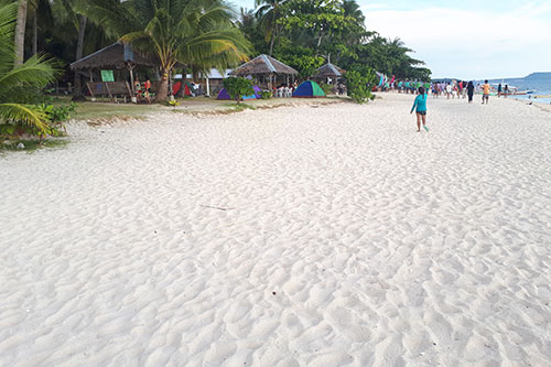 The fine and powdery white sand of Digyo Island stands out again the big crowd of campers